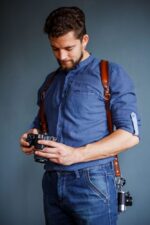 Handmade leather shoulder camera strap with adjustable width, featuring craftsmanship details suitable for photographers and accessories enthusiasts.
