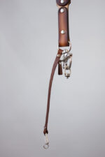 Handcrafted leather strap with high contrast stitching featuring a customizable logo, designed for professional photographers and accessory enthusiasts