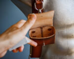Handmade leather case for carrying camera battery, flash card, and memory card, designed for photographers and accessory enthusiasts