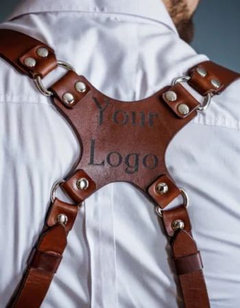 Close-up of custom logo engraving on leather camera harness backplate