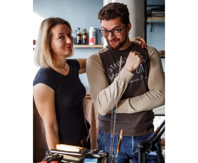 Founders of Desired Leather smiling in their workshop