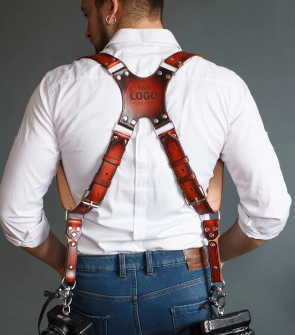 Back view of a male photographer wearing a handcrafted leather dual camera harness